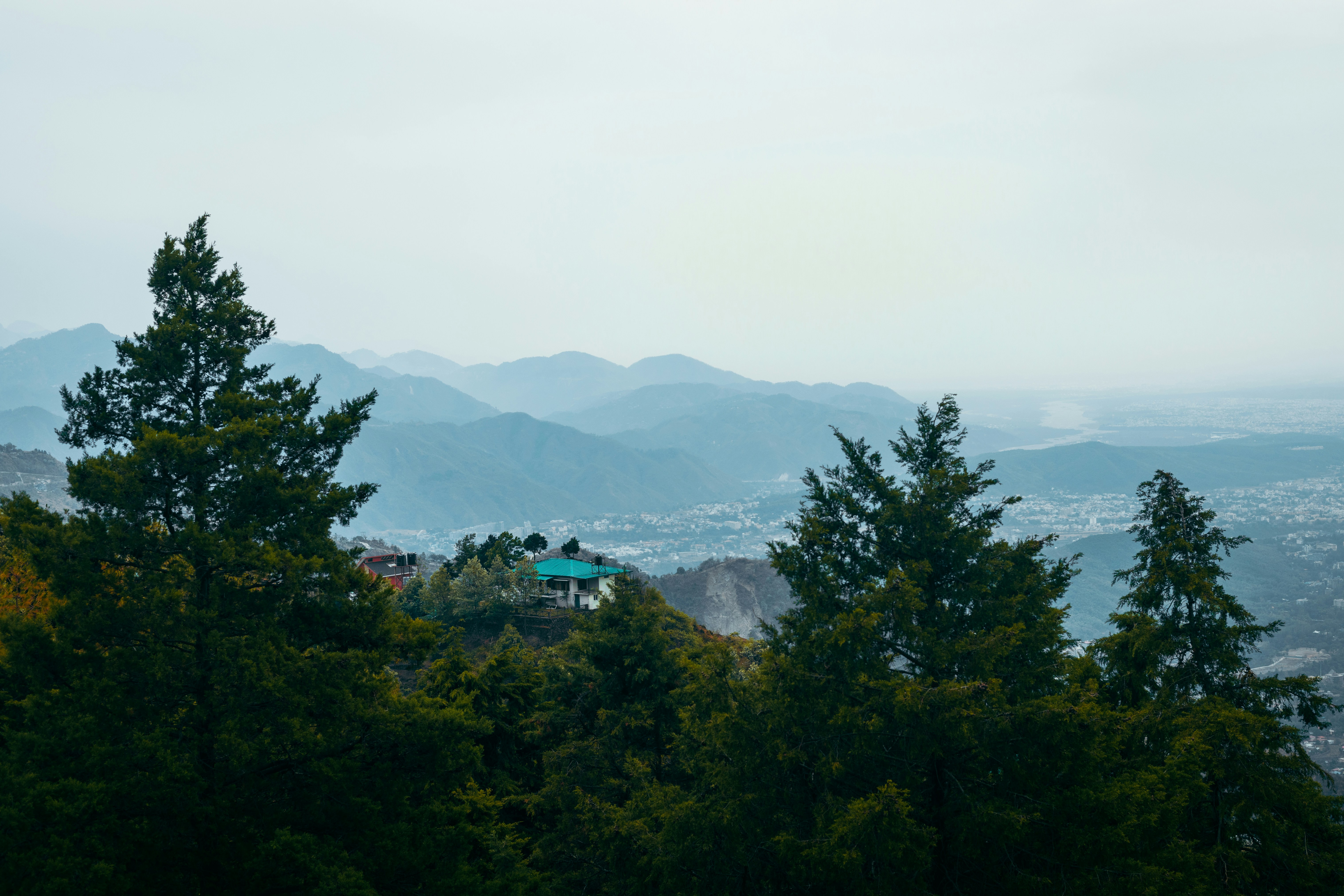 a view of the mountains from a hill top, 