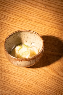 a bowl of food on a wooden table