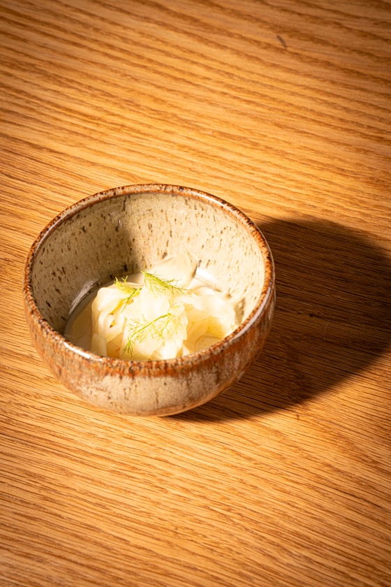 a bowl of food on a wooden table