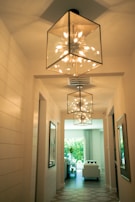 a hallway with a chandelier hanging from the ceiling