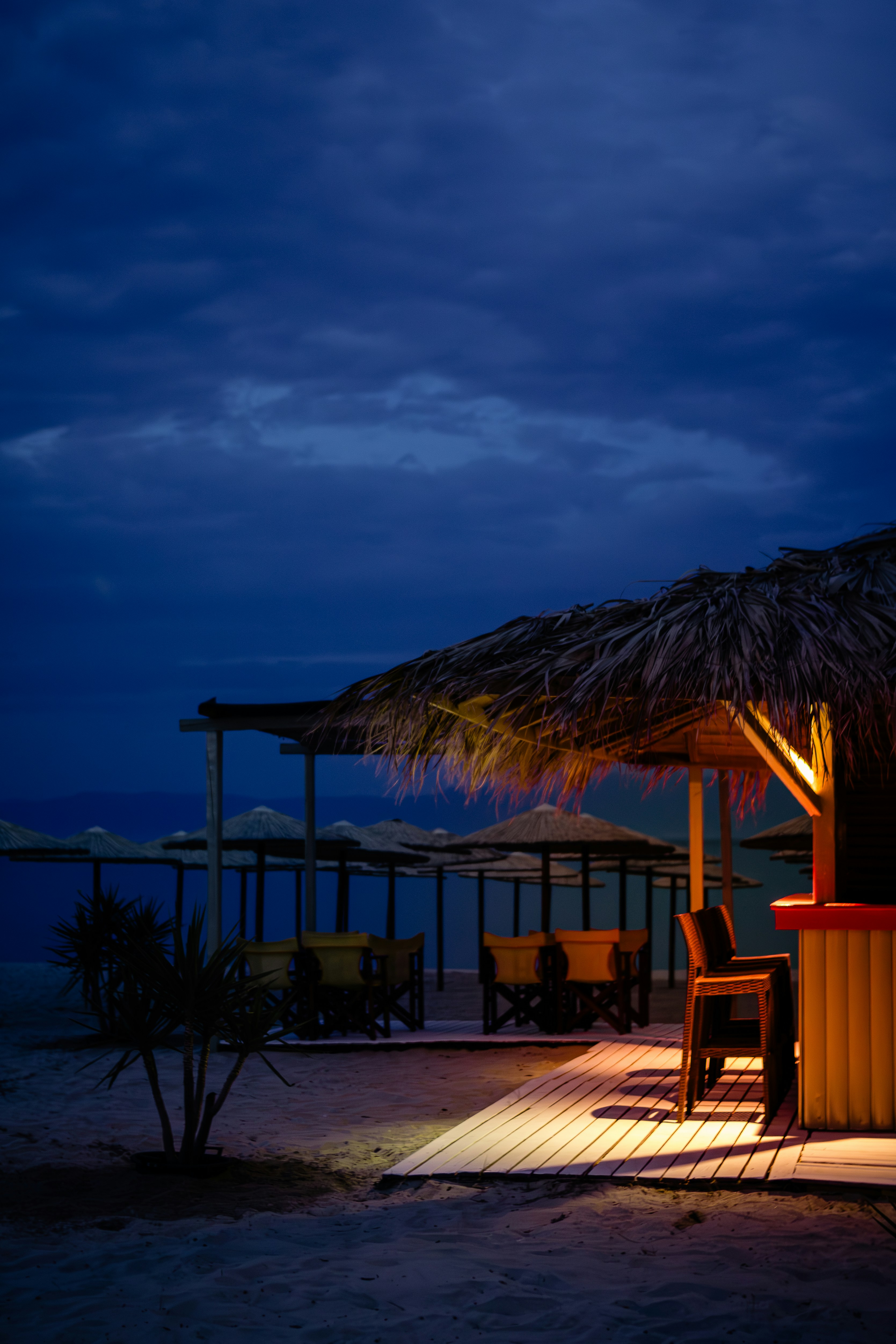 a tiki hut on the beach at night