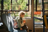 a small child sitting on a bus seat