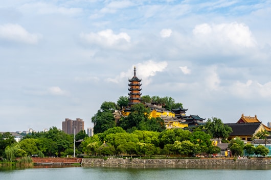 a large building sitting on top of a lush green hillside