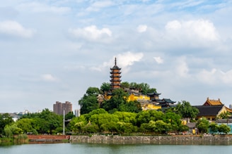 a large building sitting on top of a lush green hillside