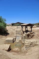 a small bridge over a small stream in the middle of a desert