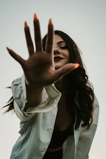 a woman with her hand up in the air