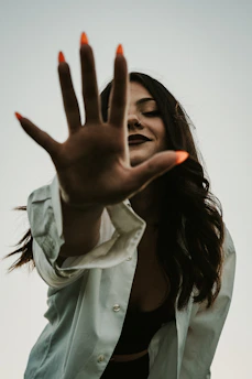 a woman with her hand up in the air