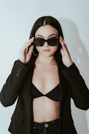 a woman wearing sunglasses and a black jacket