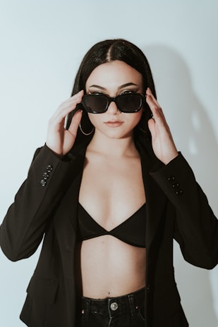 a woman wearing sunglasses and a black jacket