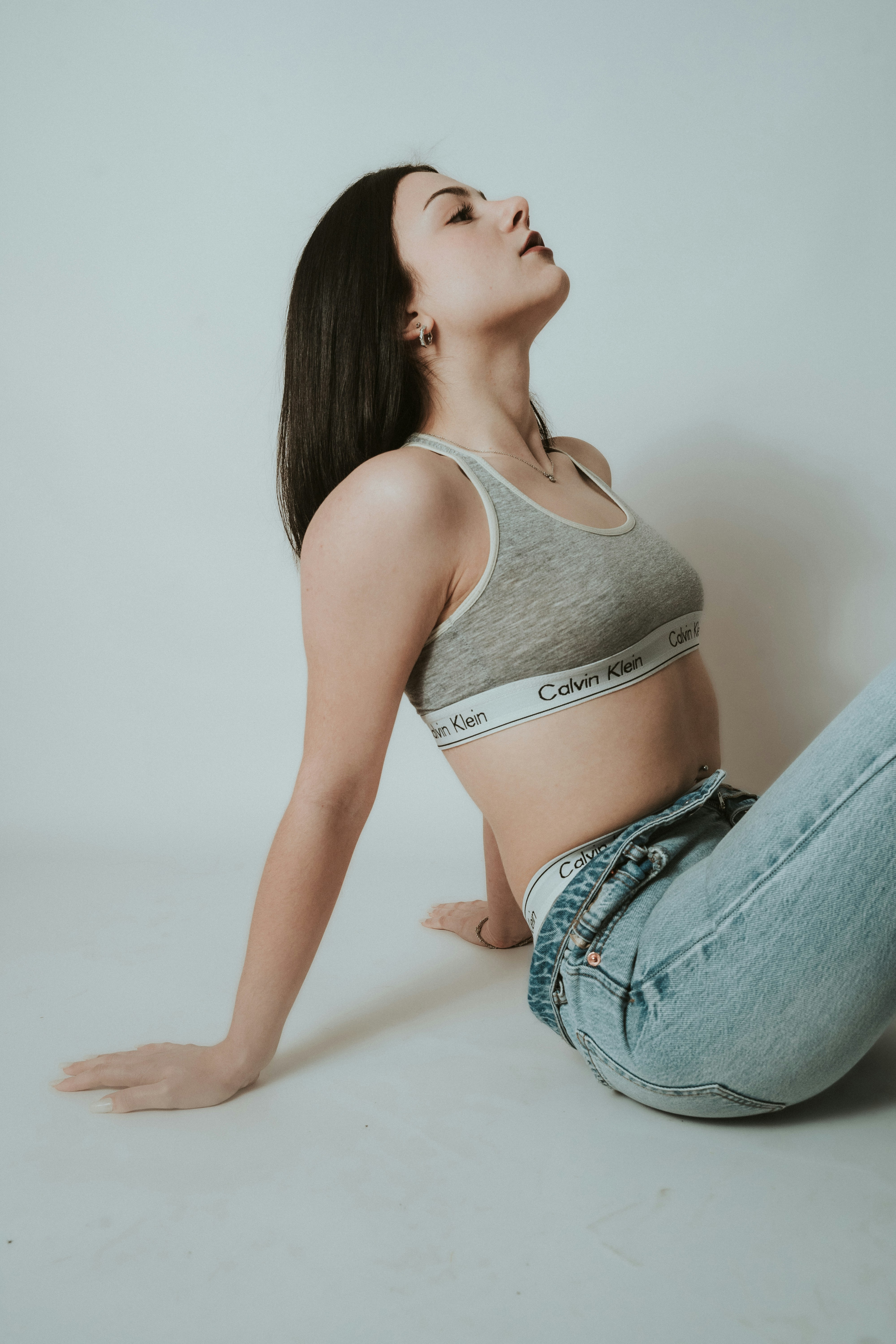 a woman sitting on the floor with her legs crossed