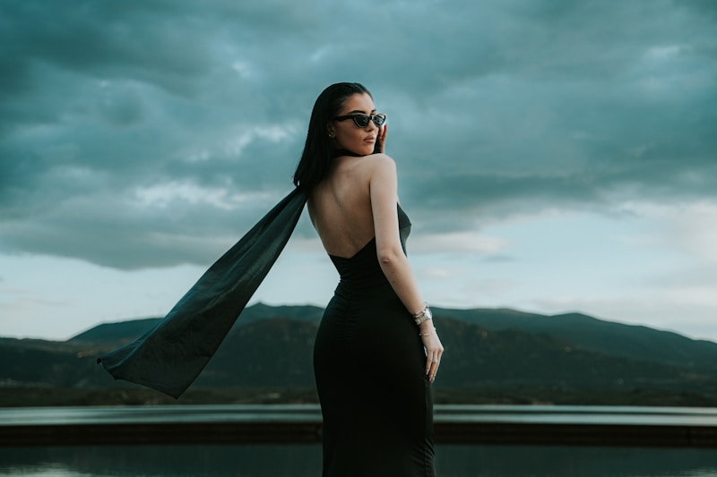a woman in a black dress and a scarf