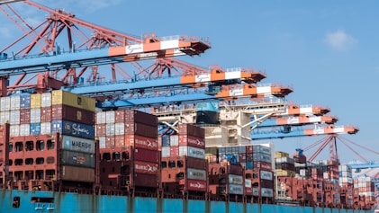 a large cargo ship loaded with containers under a blue sky