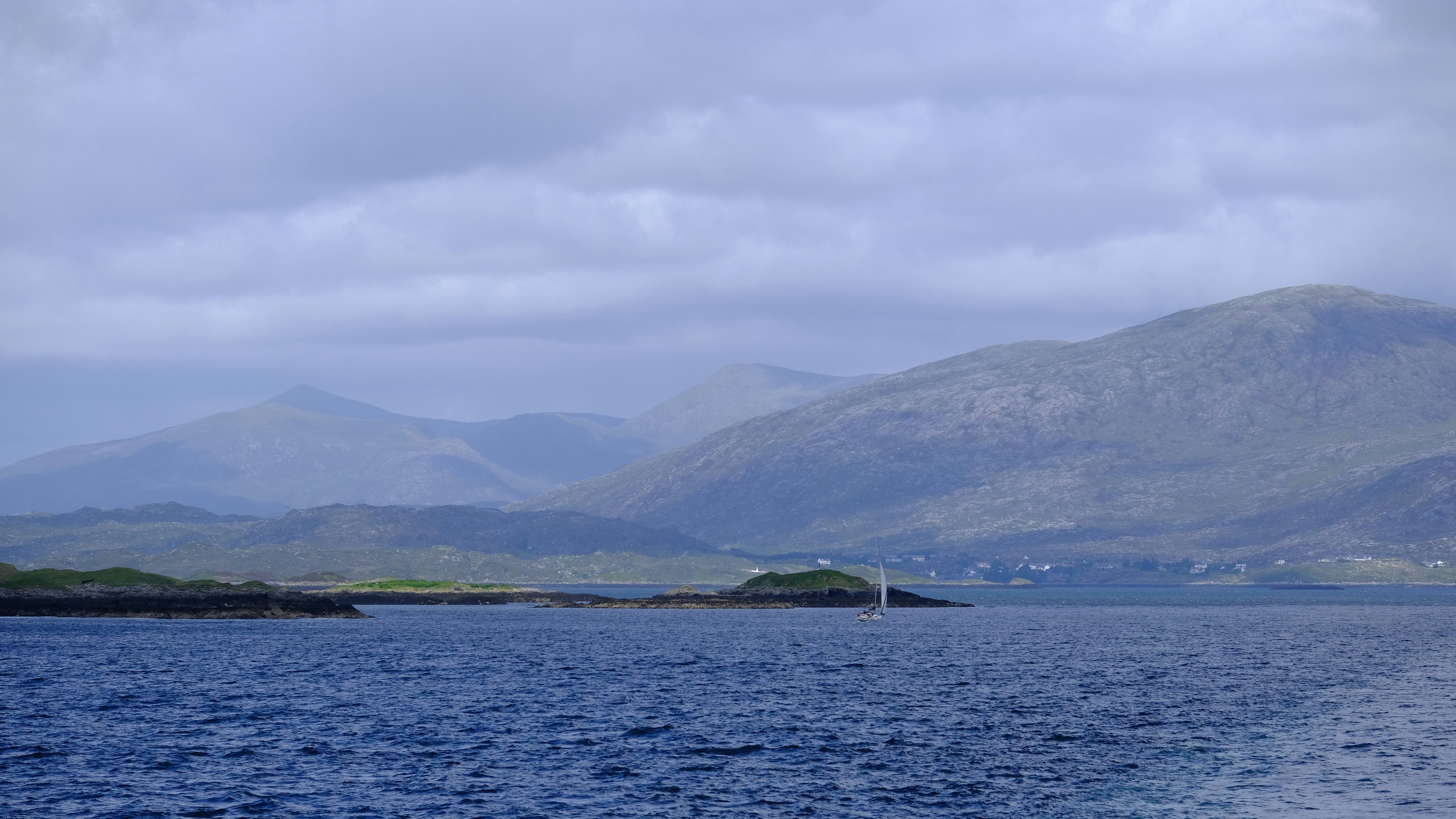 a body of water with mountains in the background, Please enjoy this picture captured in The Outer Hebrides, UK. Photographed with a Fujifilm X-T3. For all enquiries, please contact me via Unsplash and I will endeavour to reply as soon as possible. Have a great day! [Rory Tucker / The Yorkshire Photographer]