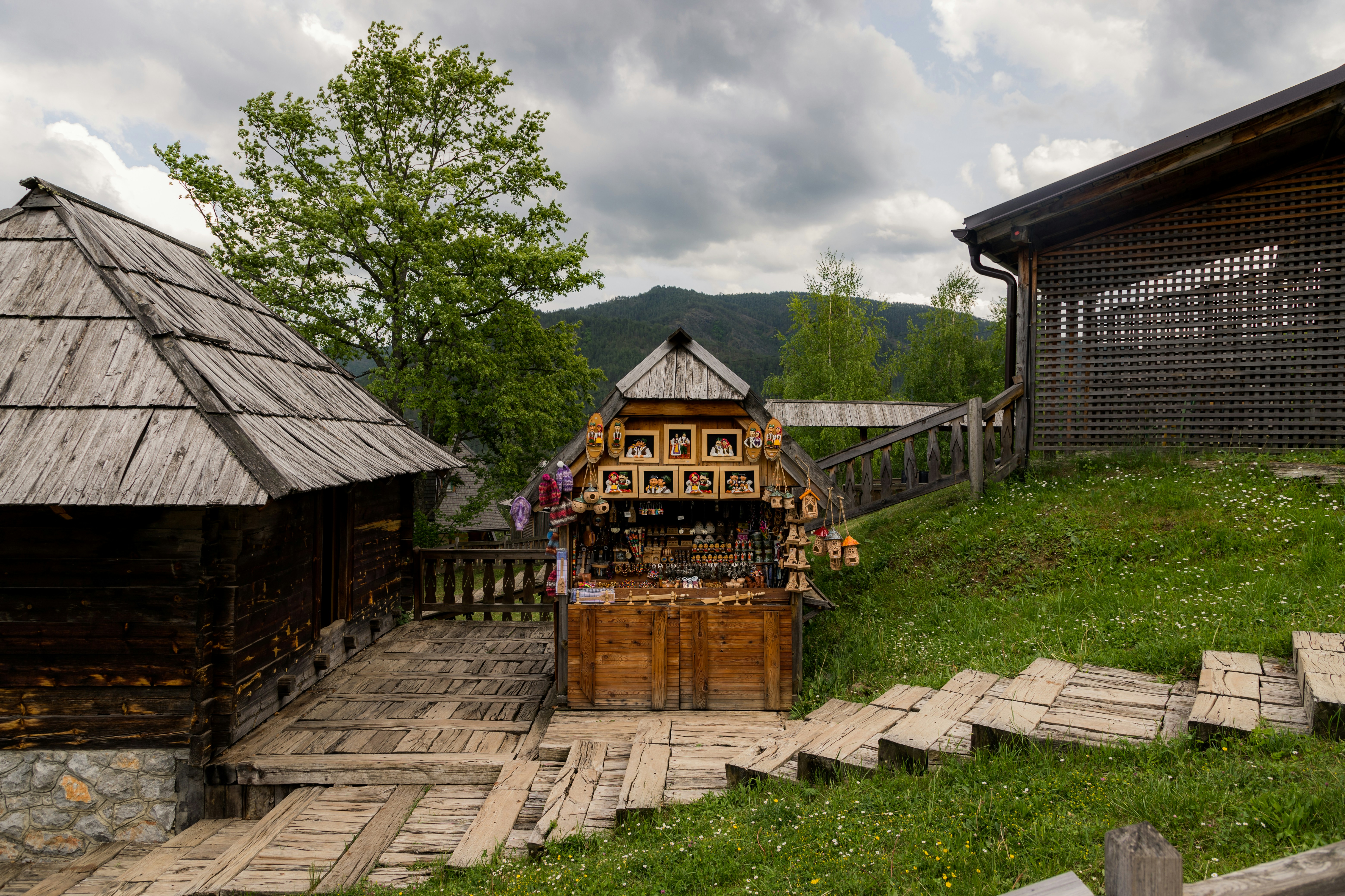 a small wooden shack sitting on top of a lush green hillside