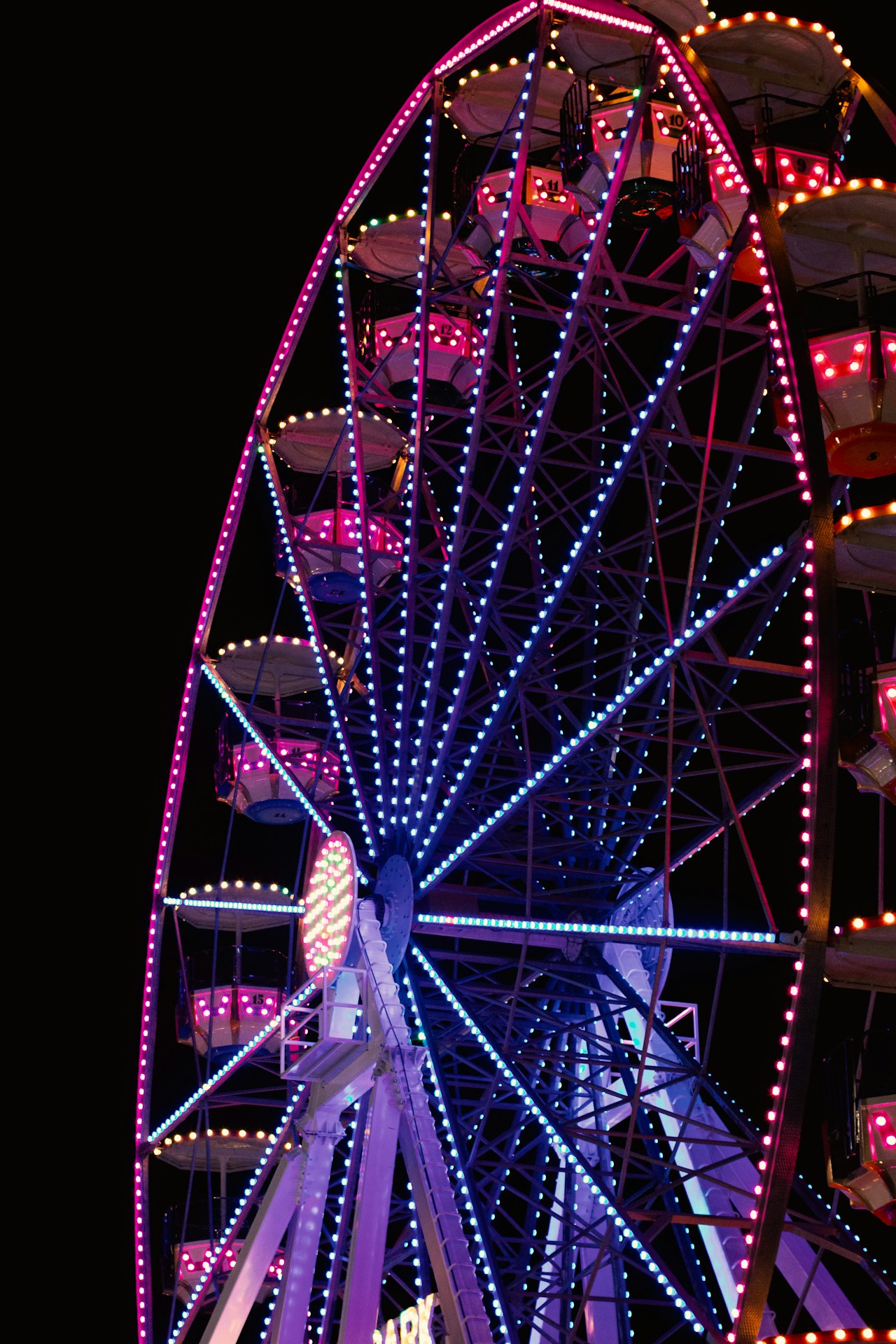 Illustrative photo — a lit ferris wheel at a state fair at night