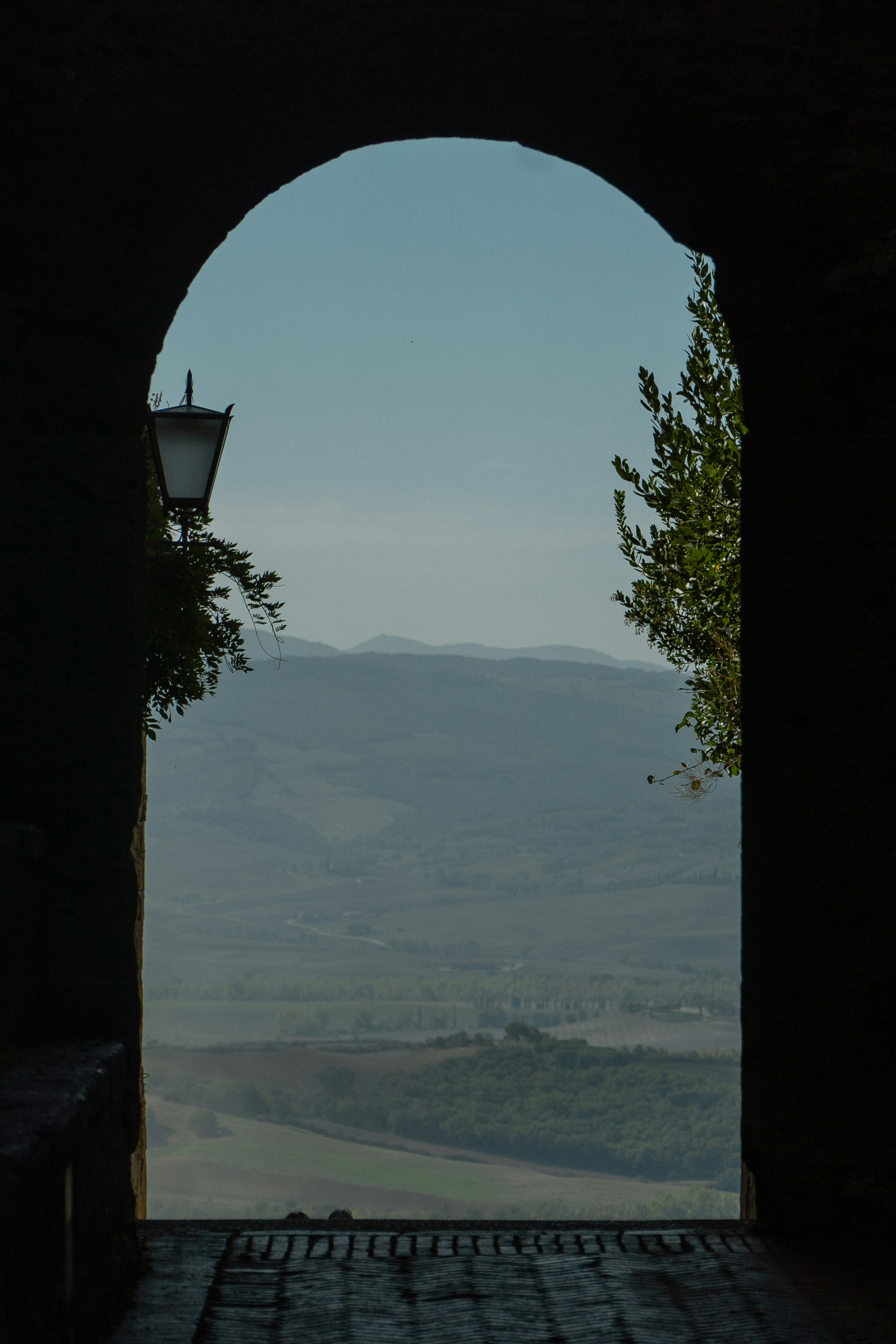 a view of a valley through an arch in a building