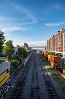 a train yard with a bridge in the background