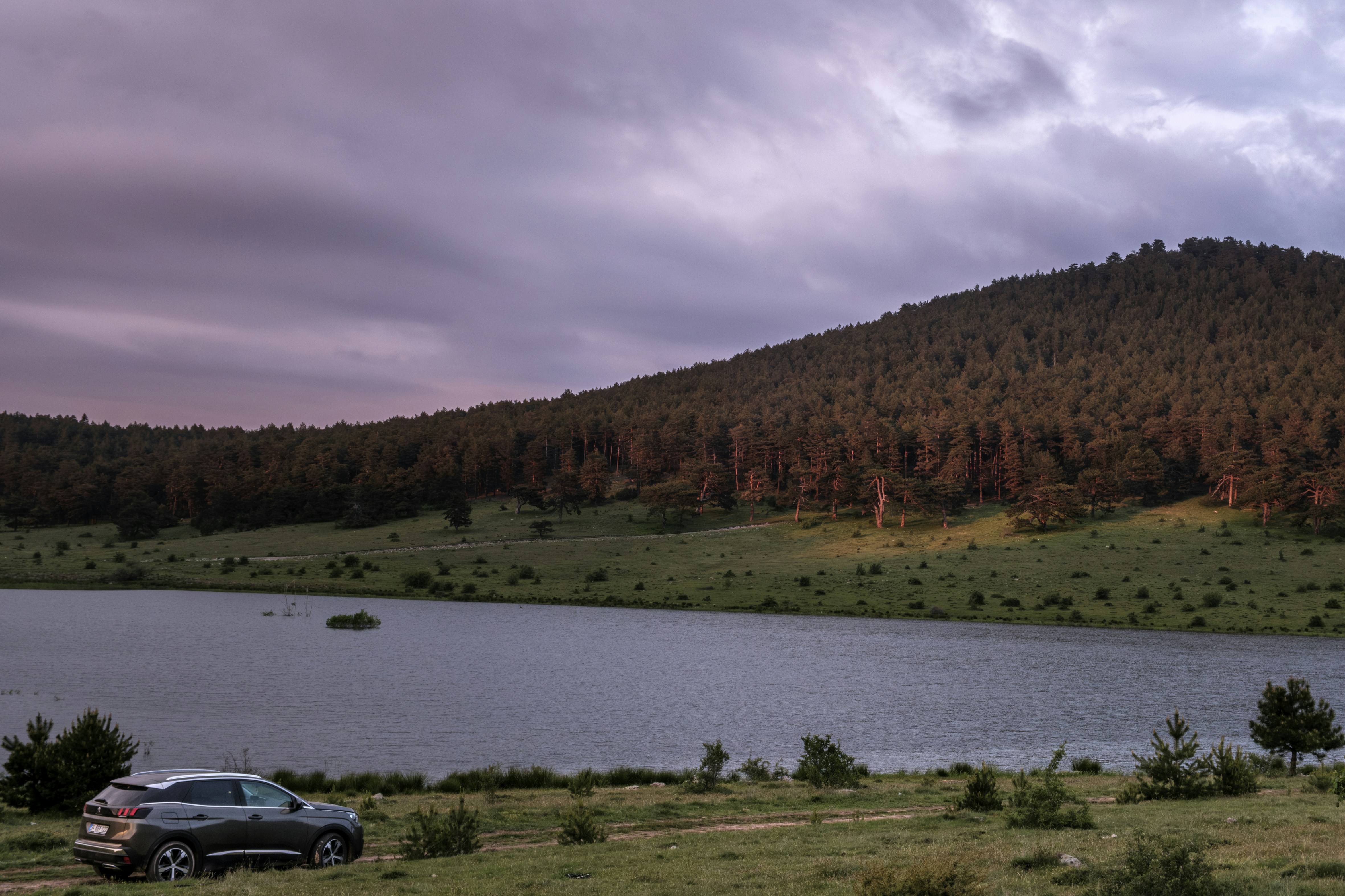 a car parked next to a body of water