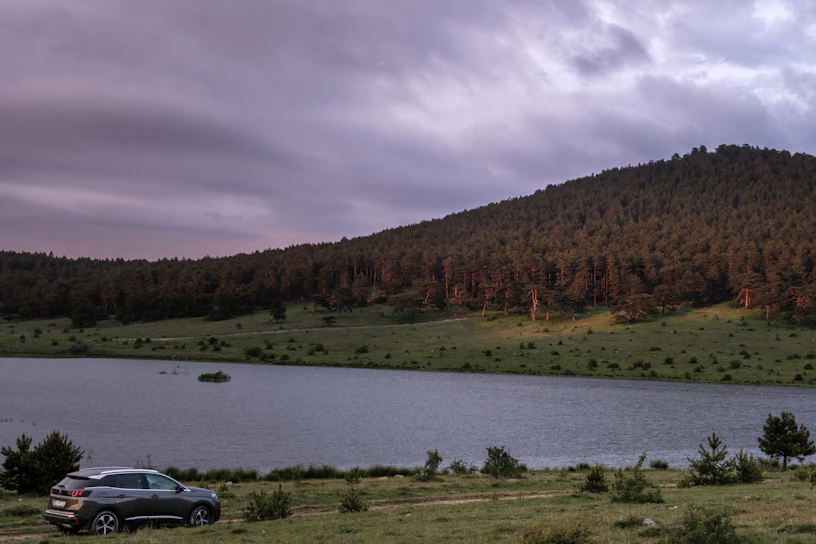 a car parked next to a body of water
