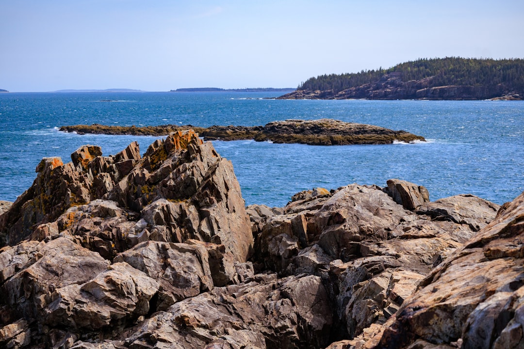 a large body of water surrounded by rocks, 3x2 aspect ratio