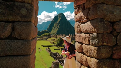 a woman in a straw hat looking out of a window