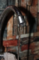a close up of a faucet with water coming out of it