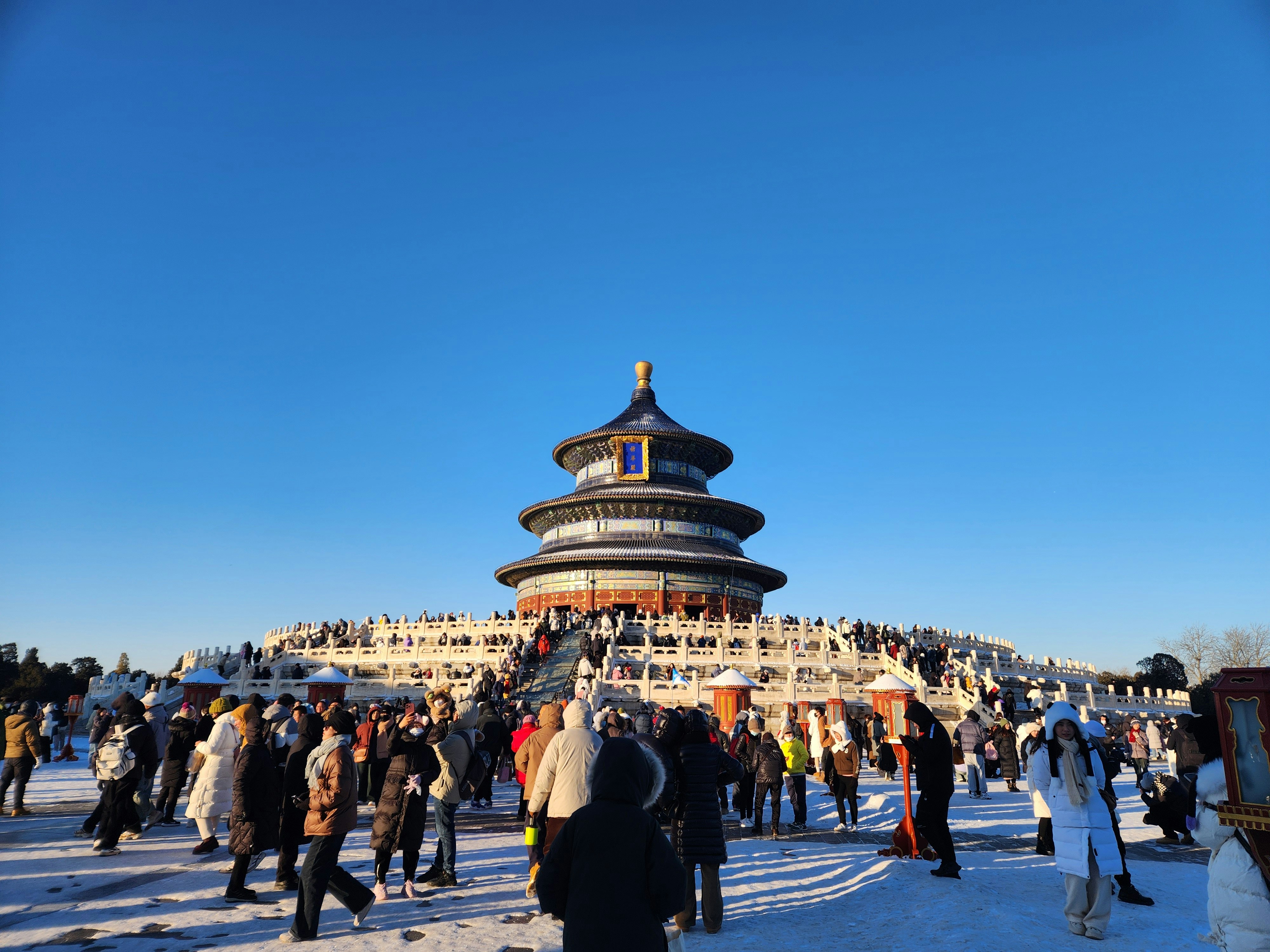 a crowd of people standing around a building in the snow