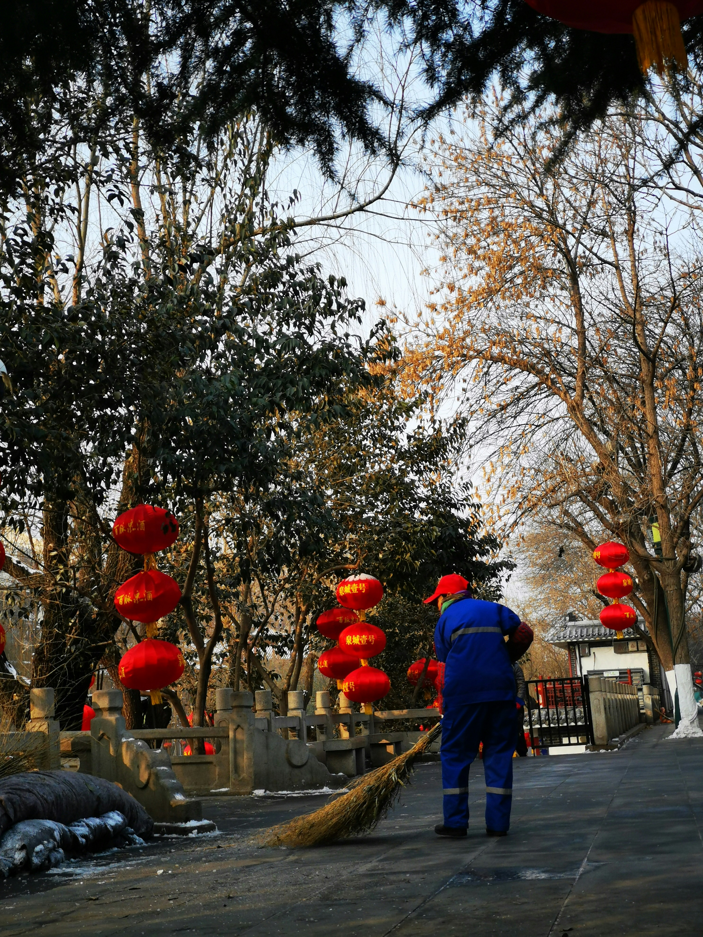 a man sweeping up the street with a broom