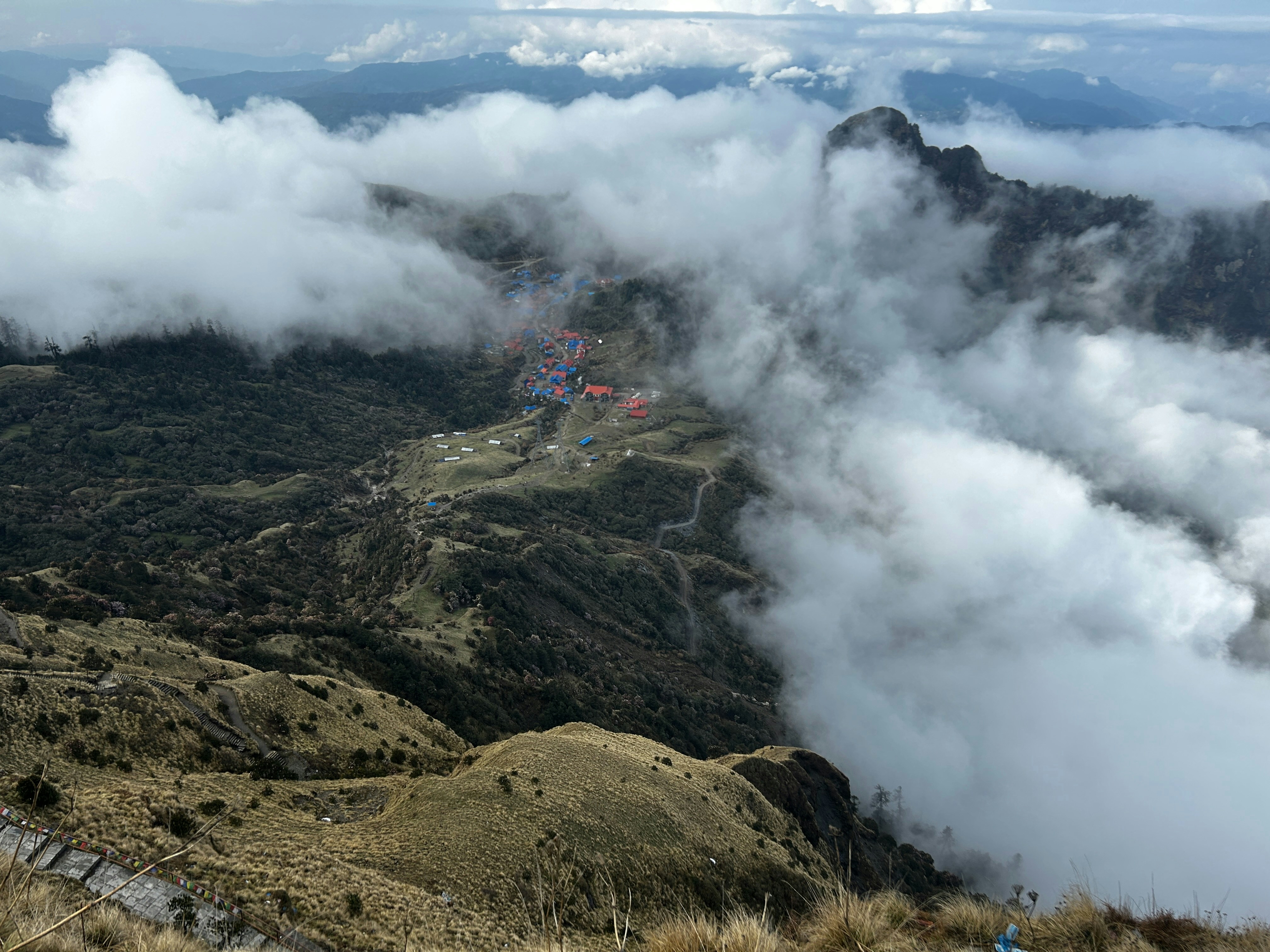a view of a mountain with a lot of clouds
