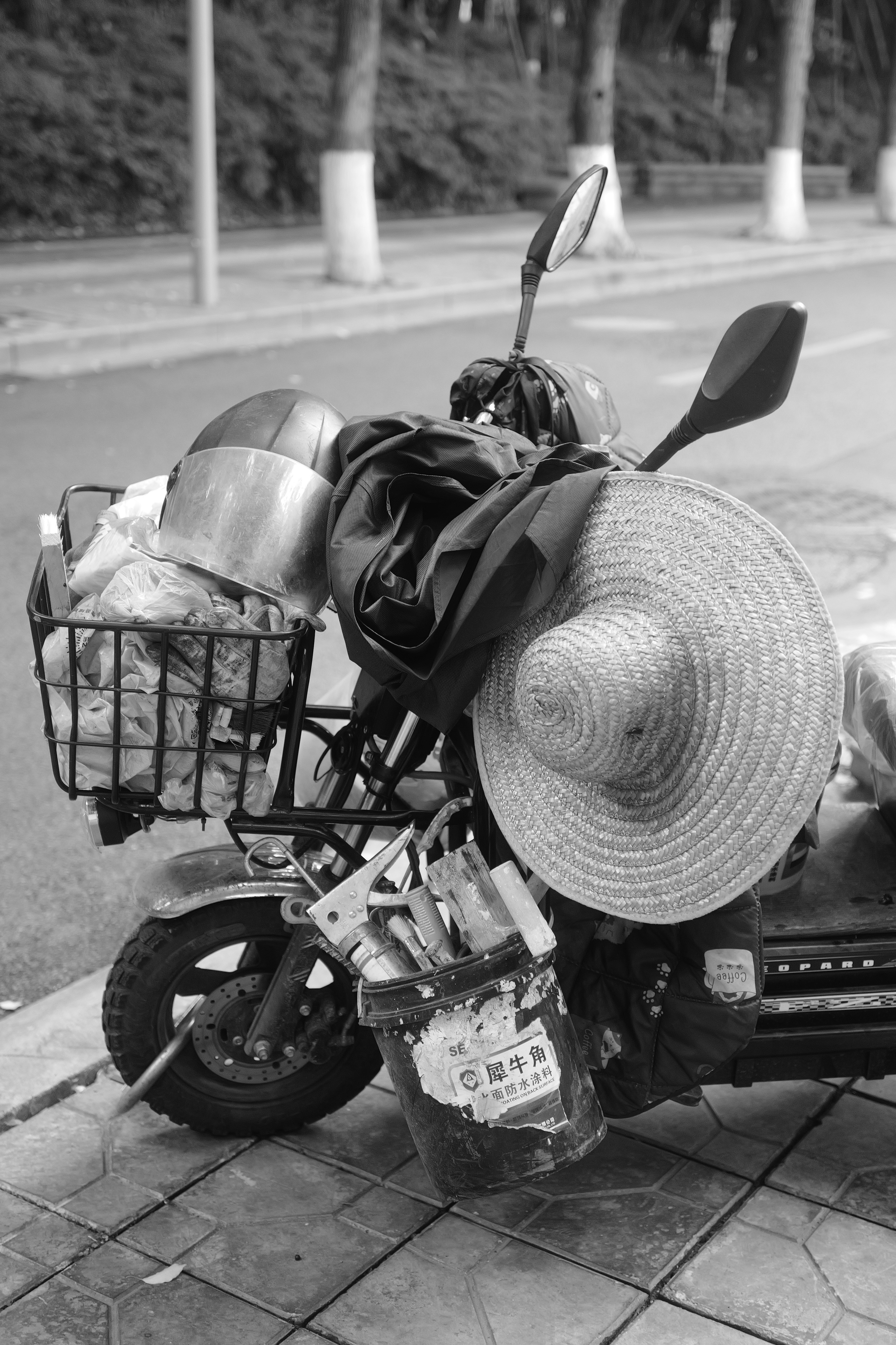 a black and white photo of a motorcycle with a basket on the back