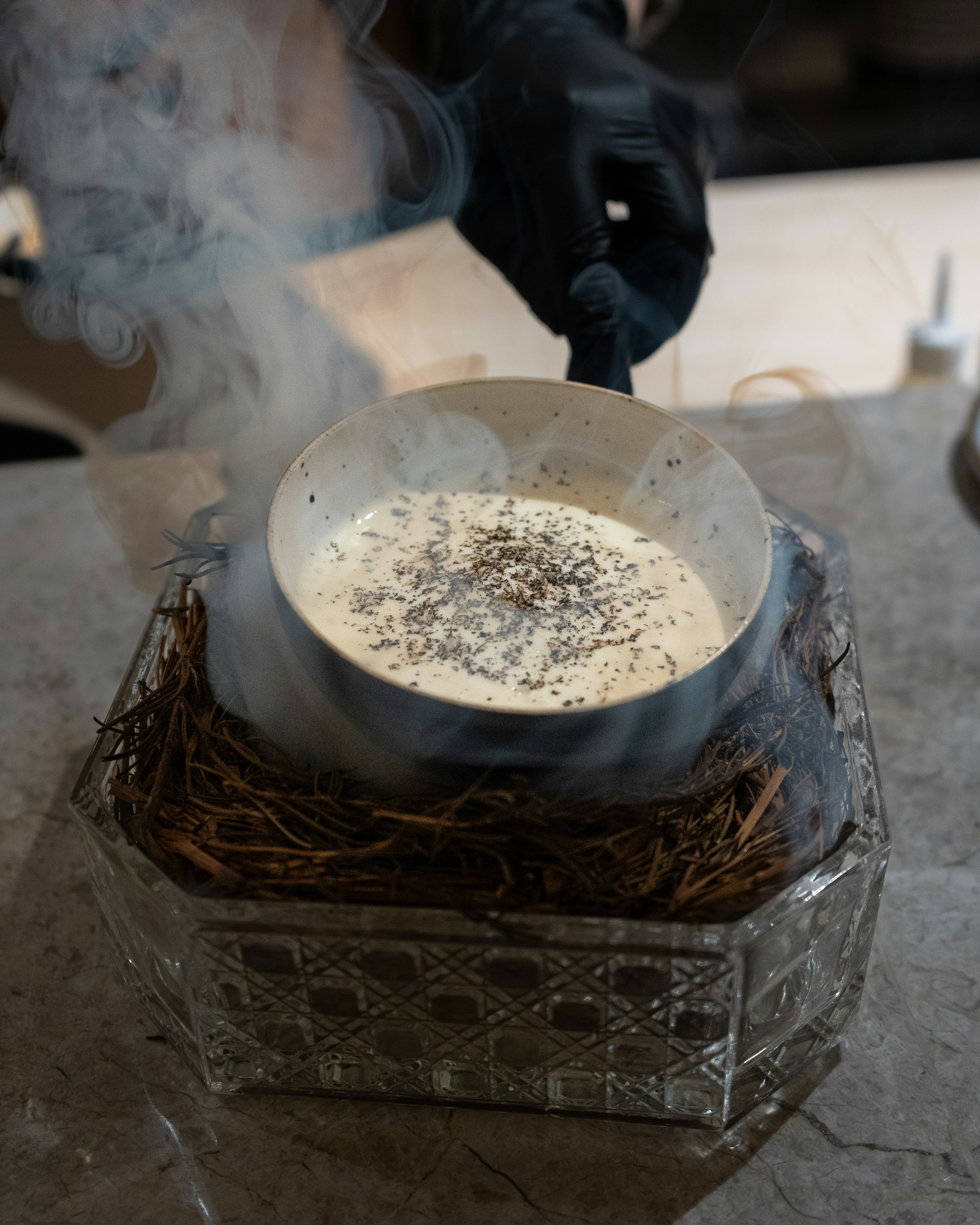 A person in black gloves stirring a bowl of food photo – Free Grey ...