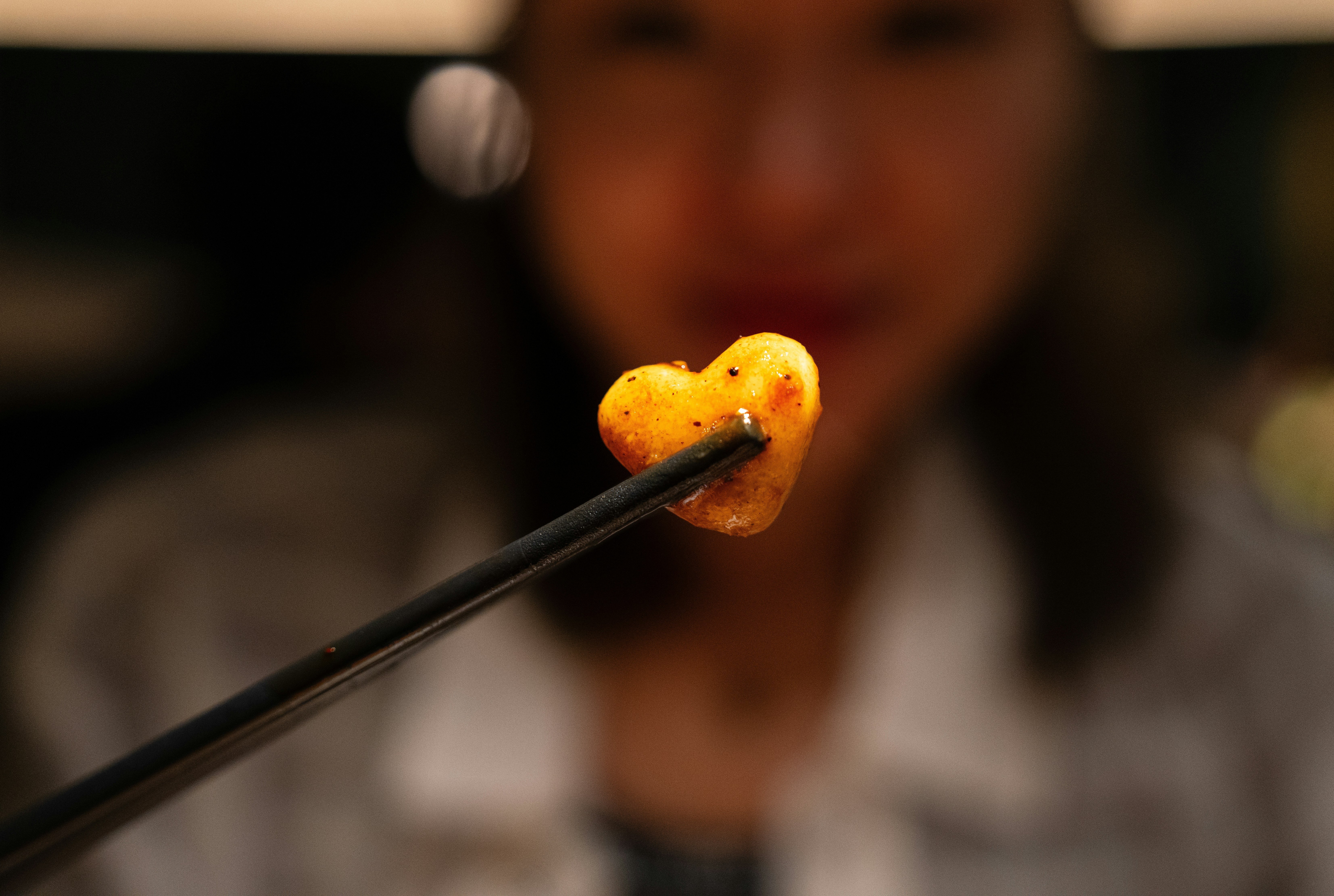 a woman holding a piece of food in her hand