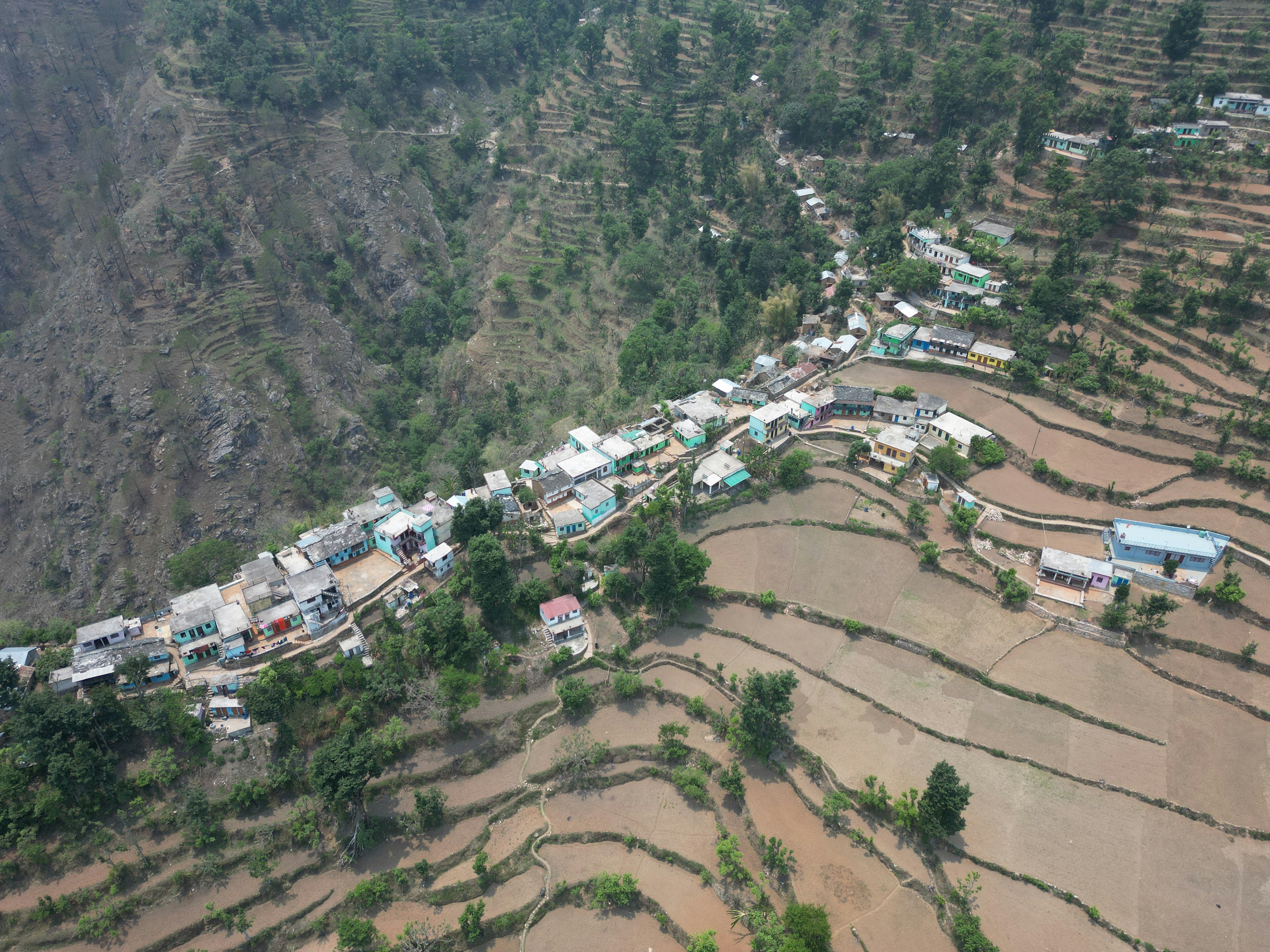 an aerial view of a village in the mountains
