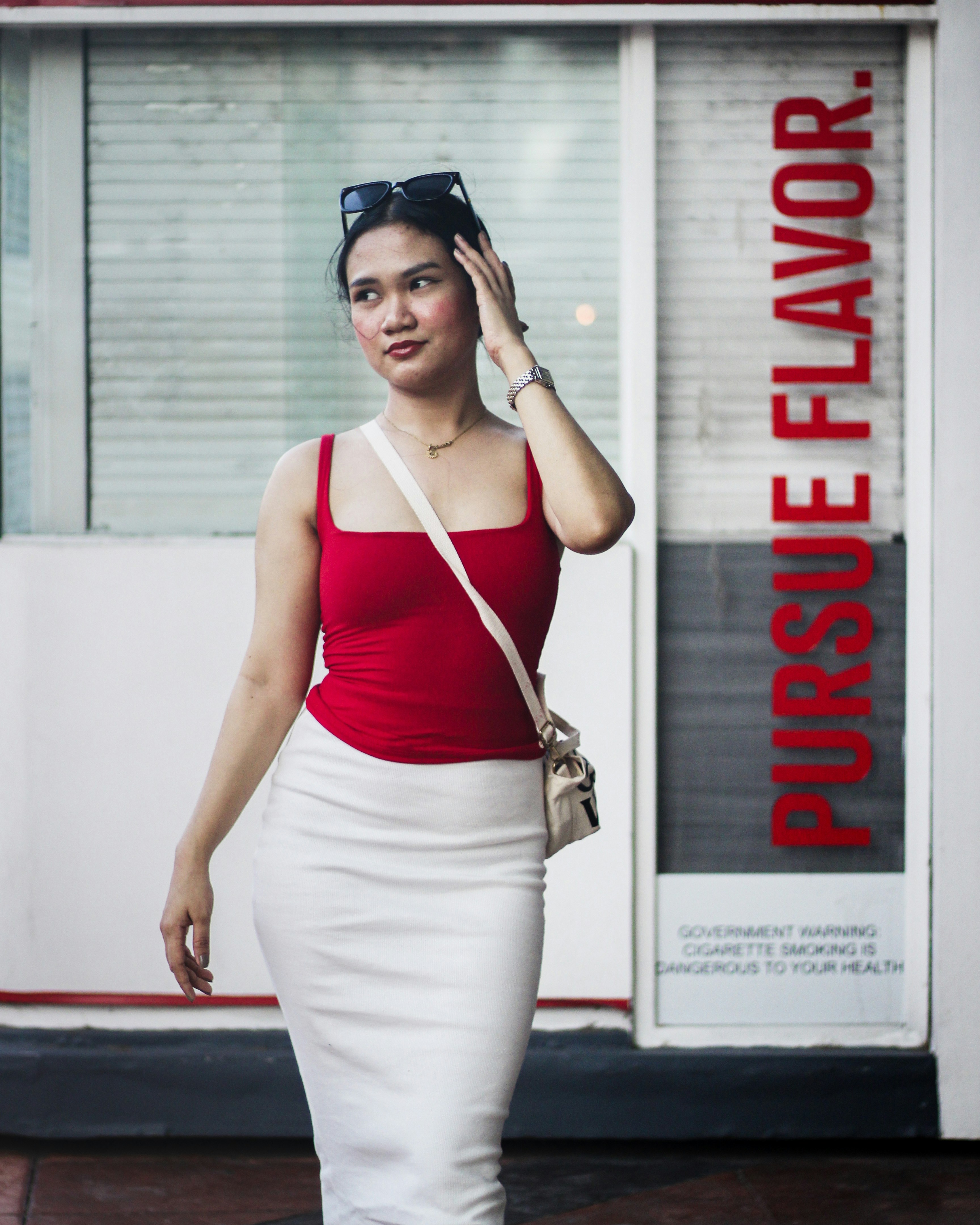 a woman in a red top and white skirt