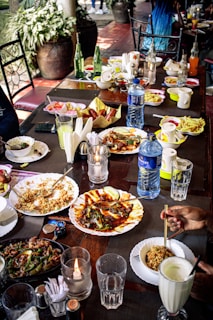a table full of plates of food and drinks