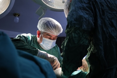 a man in a surgical gown and mask is in the operating room