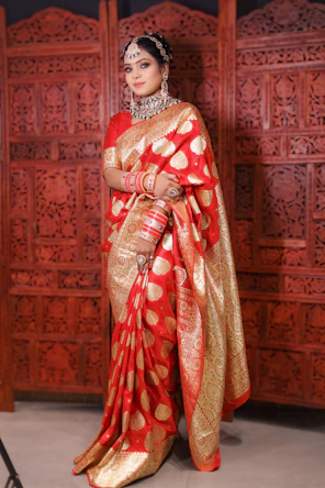 a woman in a red and gold sari