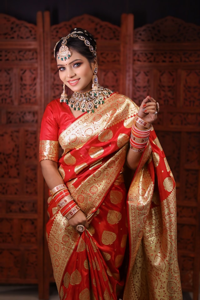 Crimson red silk Kanjivaram saree with gold zari border and bridal jewellery
