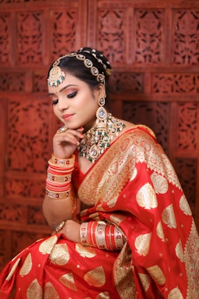 a woman in a red and gold sari