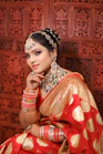 a woman in a red and gold sari