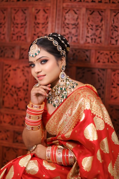 a woman in a red and gold sari