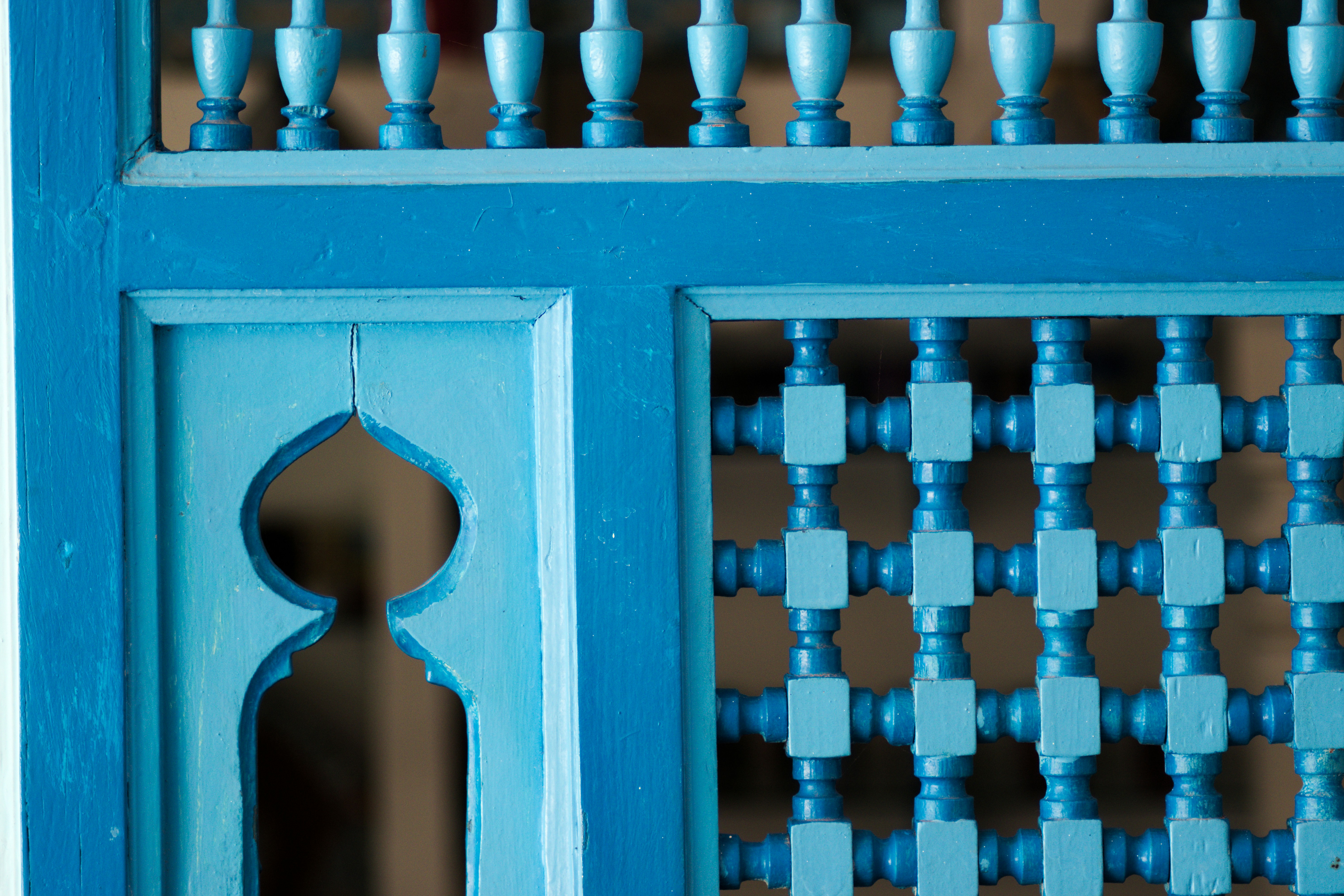 a close up of a blue door with a pattern on it
