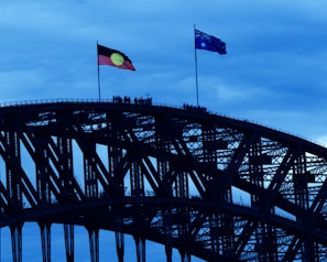 a bridge with two flags on top of it