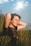 a woman sitting in a field of tall grass