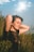 a woman sitting in a field of tall grass
