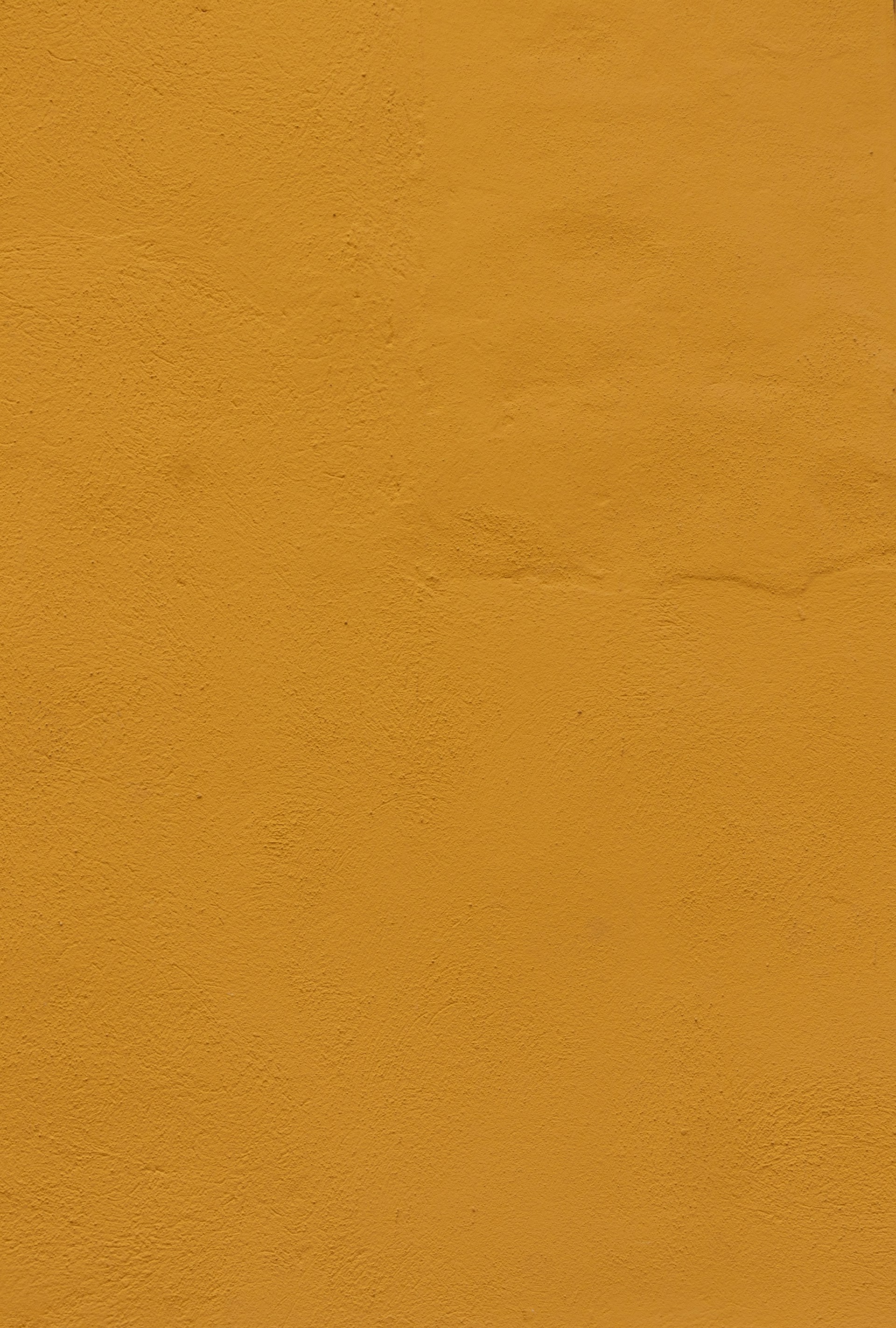 a yellow wall with a clock on it