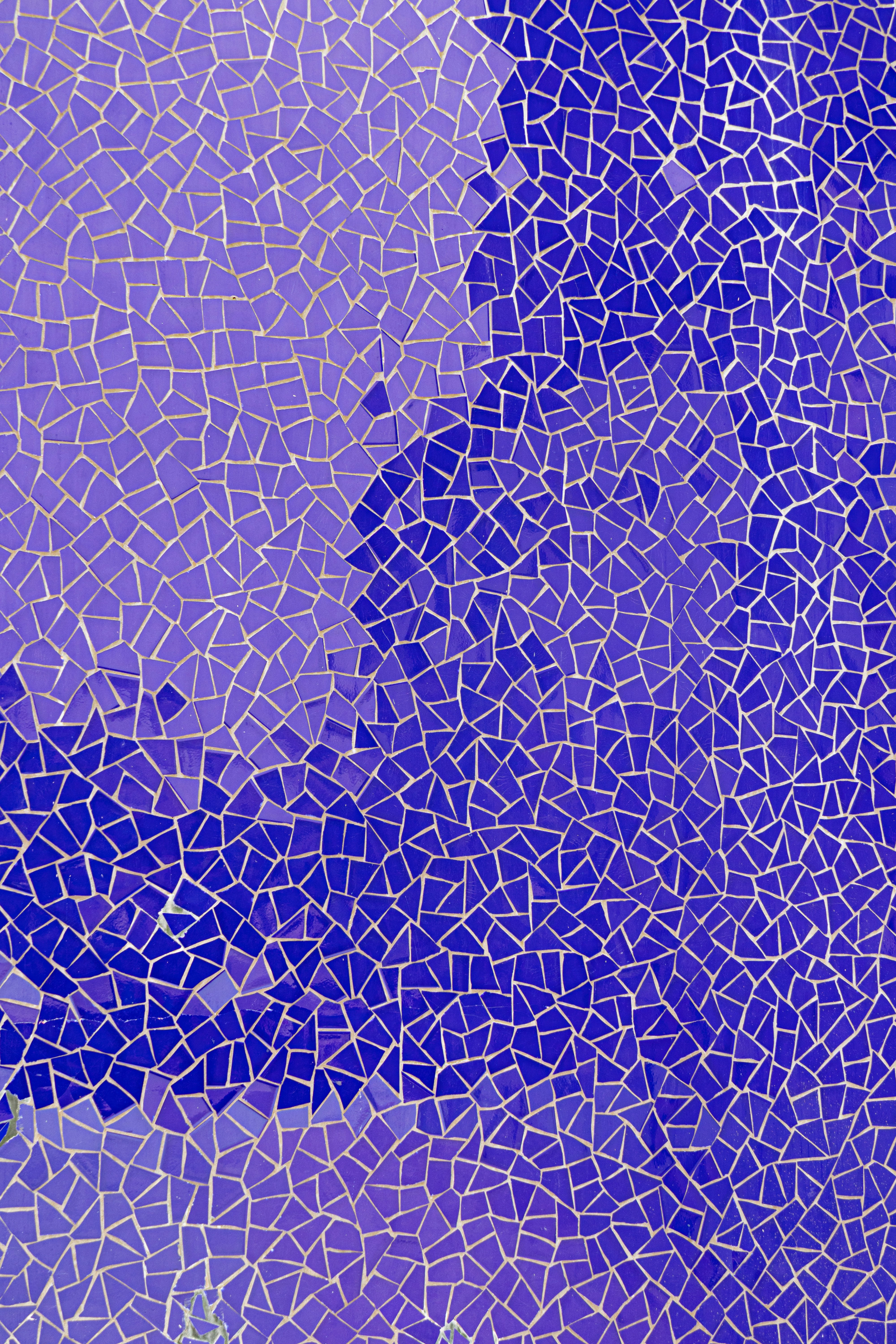 a close up of a blue and purple mosaic tile