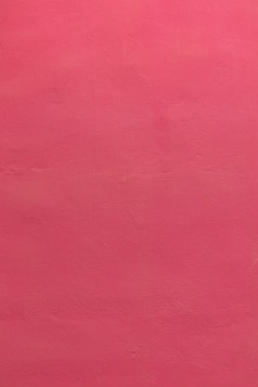 a red wall with a clock on it