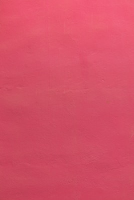 a red wall with a clock on it