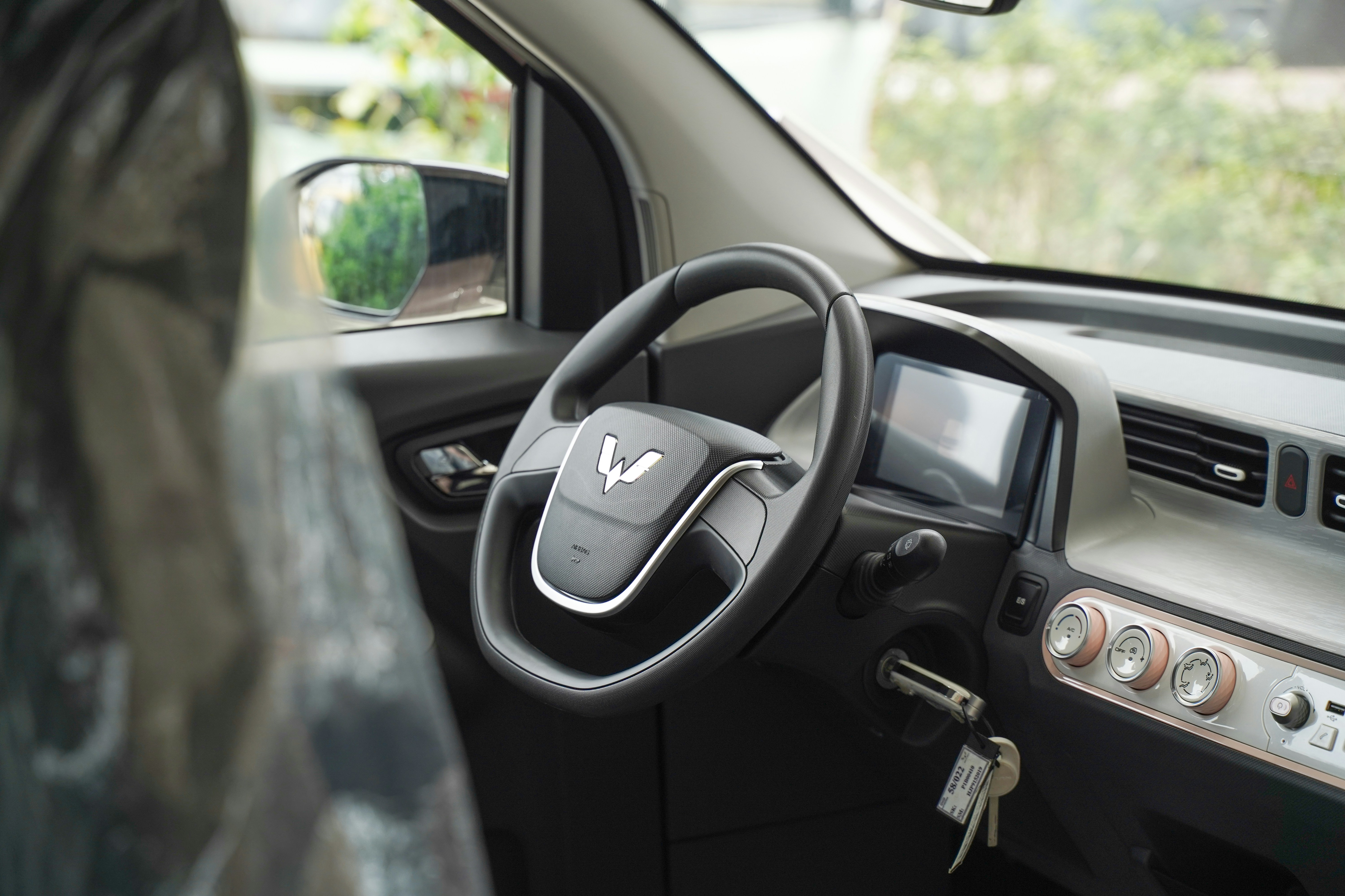 Driver using an in‑car display to locate nearby EV charging stations